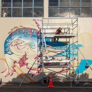 Lauren painting a mural in New Zealand. Image courtesy Lauren YS.